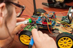 A female engineering summer camp student at the TryEngineering Summer Institute completes a hands-on engineering design challenge